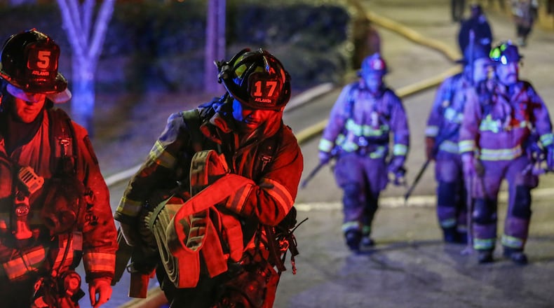 Atlanta firefighters respond to a fatal blaze at Venetian Hills Apartments on Campbellton Road in Atlanta on March 15, 2017. A $140 million verdict awarded to the family of the tenant who died in the fire was erased Friday by the Georgia Court of Appeals. (John Spink/AJC file)