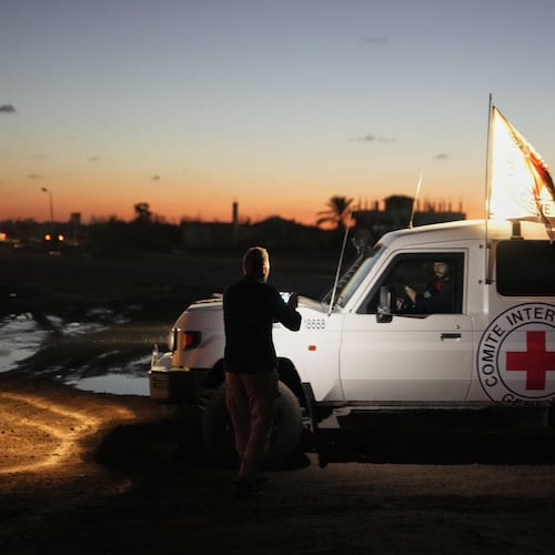 Red Cross convoy carrying the remains of a person believed to be a deceased hostage handed over by Gaza militants makes its way toward the border crossing with Israel, to be transferred to Israeli authorities, in Deir al-Balah, central Gaza Strip, Tuesday, Nov. 25, 2025. (AP Photo/Abdel Kareem Hana)