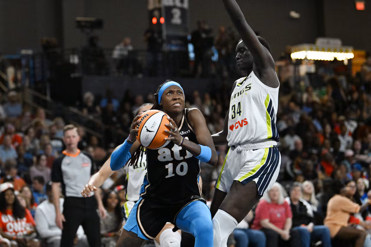 Atlanta Dream guard Rhyne Howard (10) drives against Dallas Wings forward Awak Kuier (34) during the second half of a WNBA game at Gateway Center Arena on Friday, May 22, 2026, in Atlanta. Atlanta Dream won 86-69 over Dallas Wings. (Hyosub Shin/AJC)