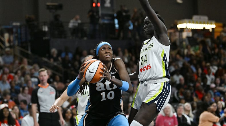 Atlanta Dream guard Rhyne Howard (10) drives against Dallas Wings forward Awak Kuier (34) during the second half of a WNBA game at Gateway Center Arena on Friday, May 22, 2026, in Atlanta. Atlanta Dream won 86-69 over Dallas Wings. (Hyosub Shin/AJC)