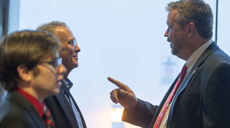 Gwinnett County School Board District 4 candidate C. Chuck Studebaker speaks with someone before a candidate forum on Oct. 16, 2018. (ALYSSA POINTER/ALYSSA.POINTER@AJC.COM)