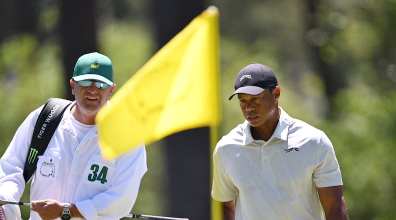 Tiger Woods and caddie Lance Bennett on third green during third round at the 2024 Masters Tournament at Augusta National Golf Club, Saturday, April 13, 2024, in Augusta, Ga. (Hyosub Shin / Hyosub.Shin@ajc.com)