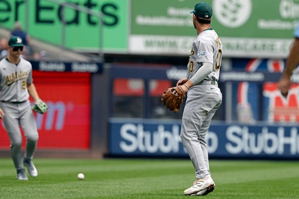 Athletics third base Max Muncy (10) watches as a fly ball hit by New York Yankees' Cody Bellinger falls in front of Athletics outfielder Tyler Soderstrom during the first inning of a baseball, game Sunday, June 29, 2025, in New York. (AP Photo/Adam Hunger)
