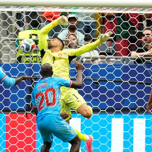 Congo's Yoane Wissa (20) scores his side's first goal against Portugal goalkeeper Diogo Costa during the World Cup Group K soccer match between Portugal and Congo in Houston, Wednesday, June 17, 2026. (AP Photo/Karen Warren)