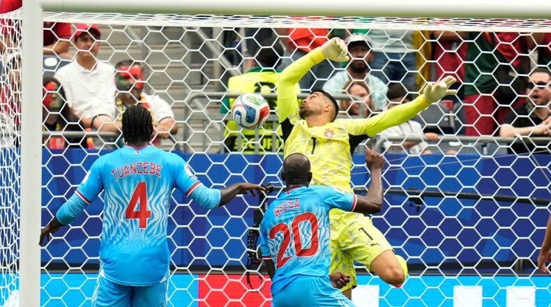 Congo's Yoane Wissa (20) scores his side's first goal against Portugal goalkeeper Diogo Costa during the World Cup Group K soccer match between Portugal and Congo in Houston, Wednesday, June 17, 2026. (AP Photo/Karen Warren)