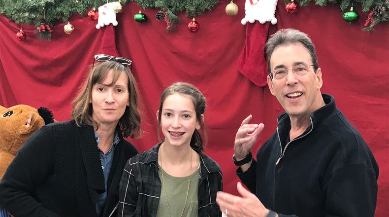 Clark Howard meets Amanda Howard, who has helped out 23 out of 27 years of the event, save for four years living in Kentucky. Her mom has brought her as a teen and she has been bringing her daughter Emily, now 12, as well. CREDIT: Rodney Ho/rho@ajc.com