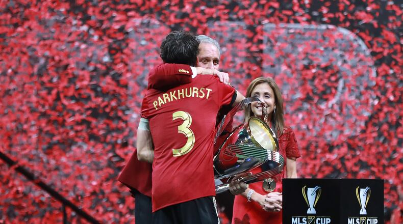 Atlanta United team captain Michael Parkhurst presents owner Arthur Blank the MLS CUP after a 2-0 victory over the Portland Timbers on Saturday, Dec 8, 2018, in Atlanta.