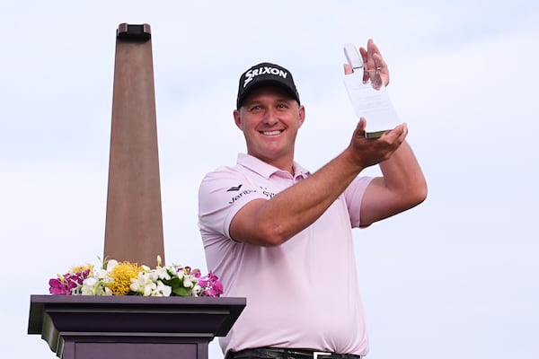 Sepp Straka, of Austria, poses with the trophy after winning the Truist Championship golf tournament at the Philadelphia Cricket Club, Sunday, May 11, 2025, in Flourtown. (AP Photo/Matt Rourke)