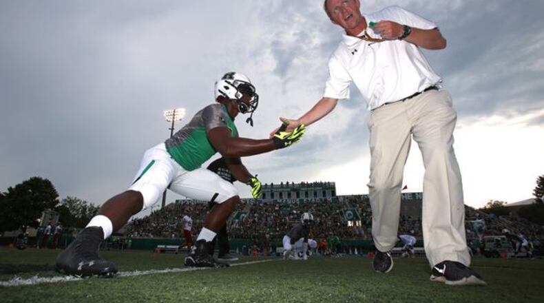August 21, 2015 - Roswell, Ga: Roswell head coach John Ford, right, greets linebacker Tre' Lamar during warms-up before their game against Lowndes Friday at Roswell High School in Roswell, Ga., August 21, 2015. Tonight is the first game of the season for both Roswell and Lowndes. PHOTO / JASON GETZ