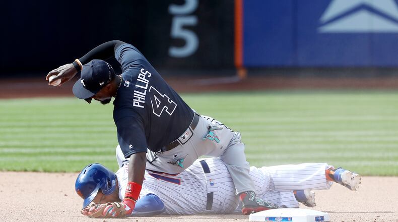 NEW YORK, NY - APRIL 03: Brandon Phillips #4 of the Atlanta Braves makes the out as Travis d'Arnaud #18 of the New York Mets slides into second in the seventh inning during Opening Day on April 3, 2017 at Citi Field in the Flushing neighborhood of the Queens borough of New York City. (Photo by Elsa/Getty Images)
