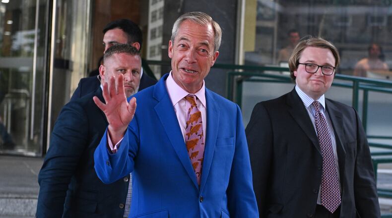 Britain's Reform UK leader Nigel Farage leaves Milbank Tower after he said he'll quit his Parliament seat and seek reelection in London, Tuesday, July 7, 2026.(AP Photo/Thomas Krych)
