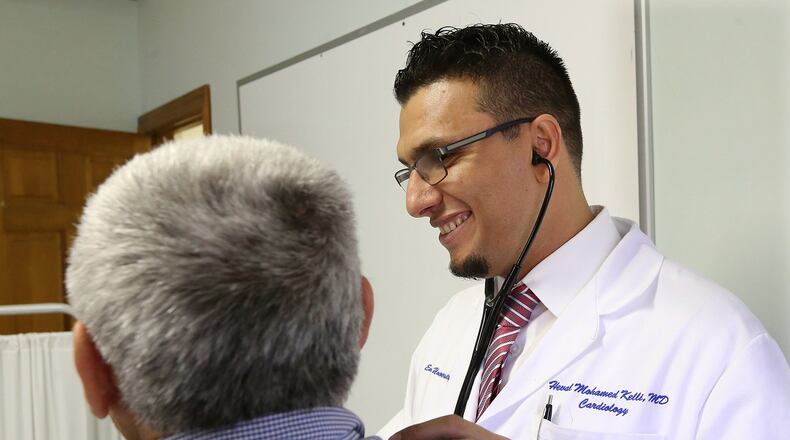 Dr. Heval Kelli, seen here treating a Syrian refugee patient at the Clarkston Community Health Center, said in the wake of the U.S. missile strike in Syria: “The Syrian regime is a killer regime, and they will do anything at any cost to stay in power. I hope we have a plan to protect people from retaliation.” Curtis Compton/ccompton@ajc.com