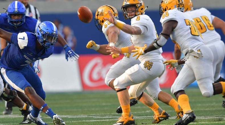 August 30, 2018 Atlanta - Kennesaw State quarterback Chandler Burks (3) tosses the football to Kennesaw State running back Darnell Holland (33) in the first half during the 2018 season opening game against the Kennesaw State at Georgia State Stadium on Thursday, August 30, 2018. HYOSUB SHIN / HSHIN@AJC.COM
