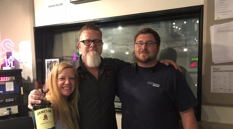 Kara Stockton and Shannon Burke pose with Jacob Boyak,  fan of the show at 10:45 a.m. on May 31, 2019. Boyak brought a 1.5 liter bottle of Jameson whiskey as a gift to the team.