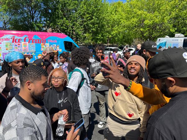 TikTok food critic Keith Lee poses for photos with fans during his "community giveback" event in Atlanta on April 3, 2024.