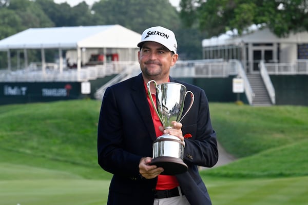 Keegan Bradley holds the championship trophy after winning the Travelers Championship golf tournament at TPC River Highlands, Sunday, June 22, 2025, in Cromwell, Conn. (AP Photo/Jessica Hill)