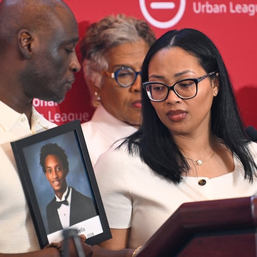 Christine Wonsley looks at a photo of her deceased son, Nolan Wells, as husband Elmore Wonsley, left, stands at her side as they appear at the National Urban League's annual conference, Thursday, July 30, 2026, in Nashville, Tenn. (John Amis/AP)