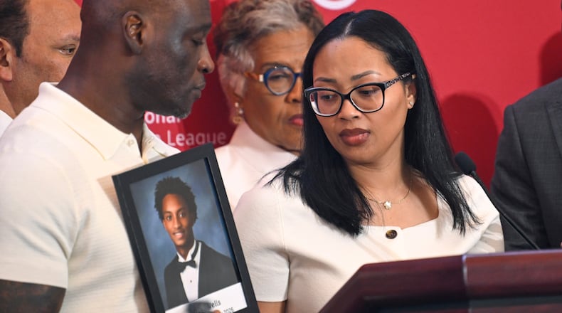 Christine Wonsley looks at a photo of her deceased son, Nolan Wells, as husband Elmore Wonsley, left, stands at her side as they appear at the National Urban League's annual conference, Thursday, July 30, 2026, in Nashville, Tenn. (John Amis/AP)