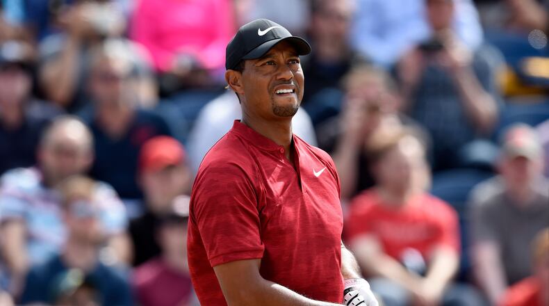 Tiger Woods reacts after playing his shot from the third tee during the final round of The Open Championship golf tournament at Carnoustie Golf Links.