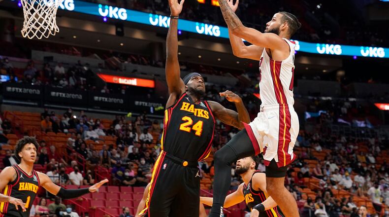 Miami Heat forward Caleb Martin drives to the basket as Hawks center Johnny Hamilton (24) defends during the second half of a preseason NBA game, Monday, Oct. 4, 2021, in Miami. (Marta Lavandier/AP)