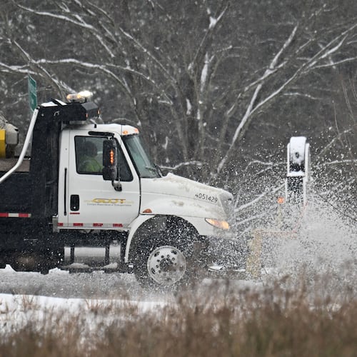 A Georgia Department of Transportation plow truck clears the roads on Scenic Highway in Lawrenceville in January 2025. A year later, North Georgia is again bracing for a winter storm, and Gov. Brian Kemp has already declared a state of emergency for all counties for the next seven days. (Hyosub Shin/AJC 2025)