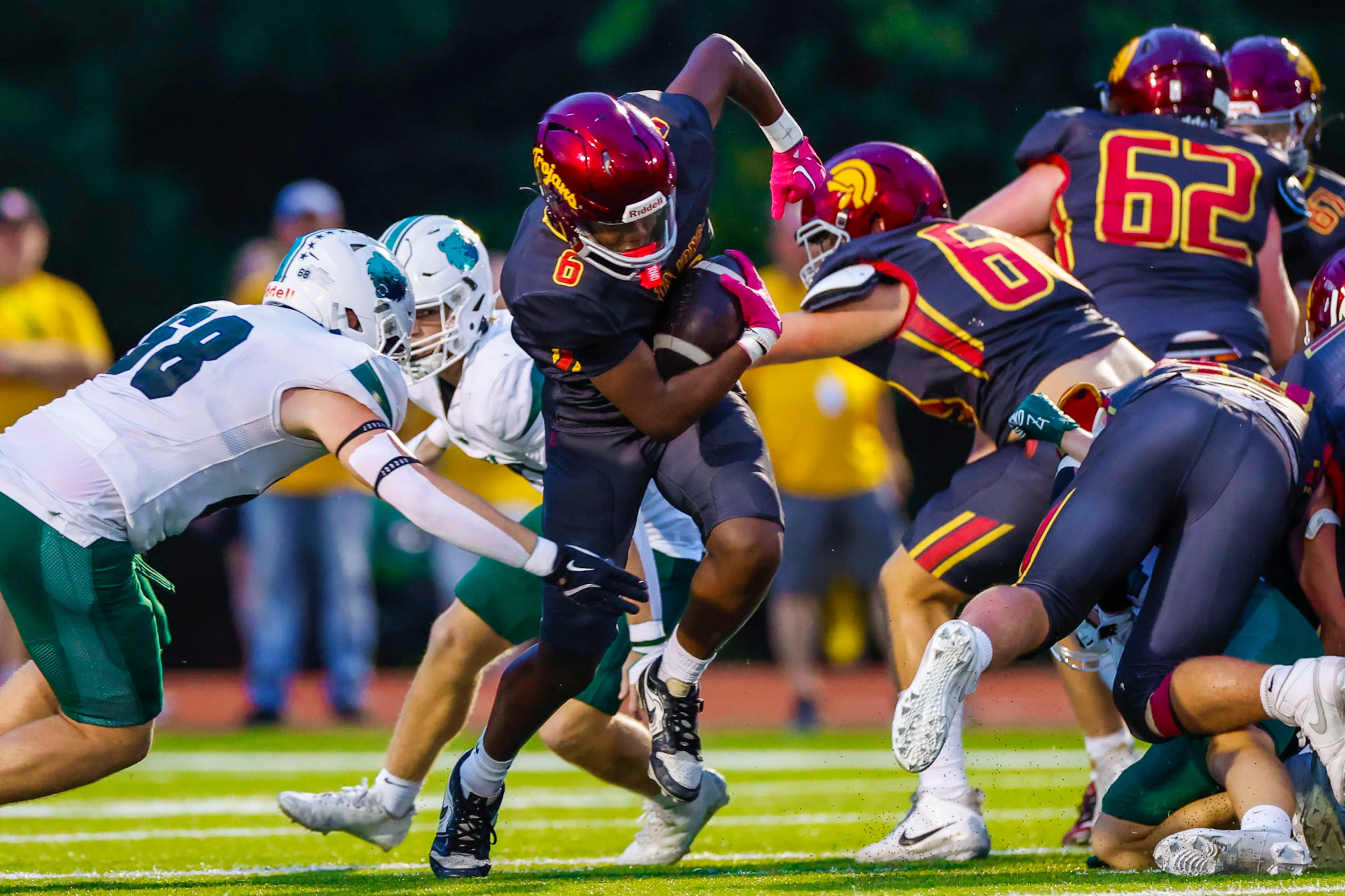 Lassiter flanker Drew McGee (center) gets tackled during the first half against Creekview at Lassiter High School on Friday, Sept. 5, 2025, in Marietta. (Oscar Guevara Saenz for the AJC)