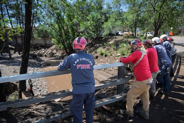 Rescue Personnel from Las Cruces, N.M., as well as the surrounding areas standby in the town of Ruidoso, N.M., as they expect rain later in the forecast, Wednesday, July 9, 2025, after the town got hit with a major flooding the day before. (AP Photo/Roberto E. Rosales)