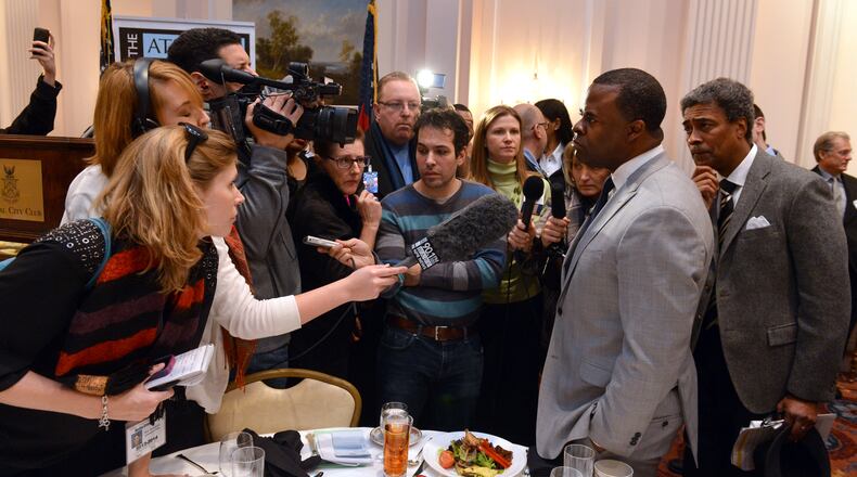 Atlanta Mayor Kasim Reed fields questions from reporters after speaking at an Atlanta Press Club luncheon Friday, January 31, 2014, at the Capital City Club.
