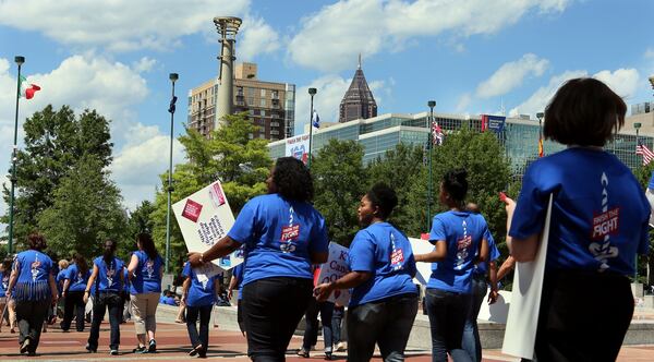 An estimated 450 American Cancer Society employees, volunteers and supporters march through Centennial Olympic Park in downtown Atlanta after a rally to celebrate the organization’s 100th birthday in 2013. The nonprofit announced layoffs June 10, 2020. File photo. (PHIL SKINNER/AJC)