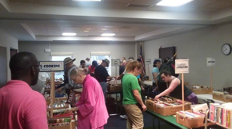 Inside the Decatur Library, book sale patrons enjoy an opportunity to browse through selections. COURTESY OF FRIENDS OF DECATUR LIBRARY