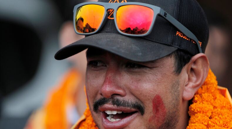 FILE - Nepalese mountaineer Nirmal Purja, who became the fastest climber of the world's 14 highest peaks, arrives at the airport in Kathmandu, Nepal, on Oct. 30, 2019. (AP Photo/Niranjan Shrestha, File)