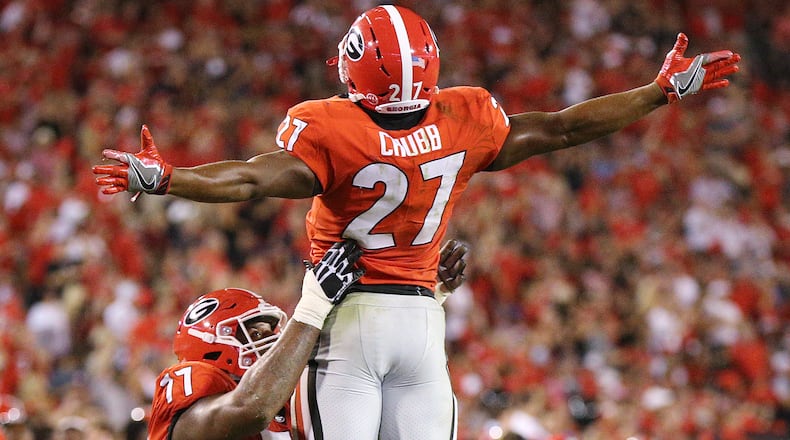 Georgia running back Nick Chubb is hoisted in the air by offensive lineman Isaiah Wynn scoring a touchdown for a 31-0 lead against Appalachian State. Curtis Compton/ccompton@ajc.com