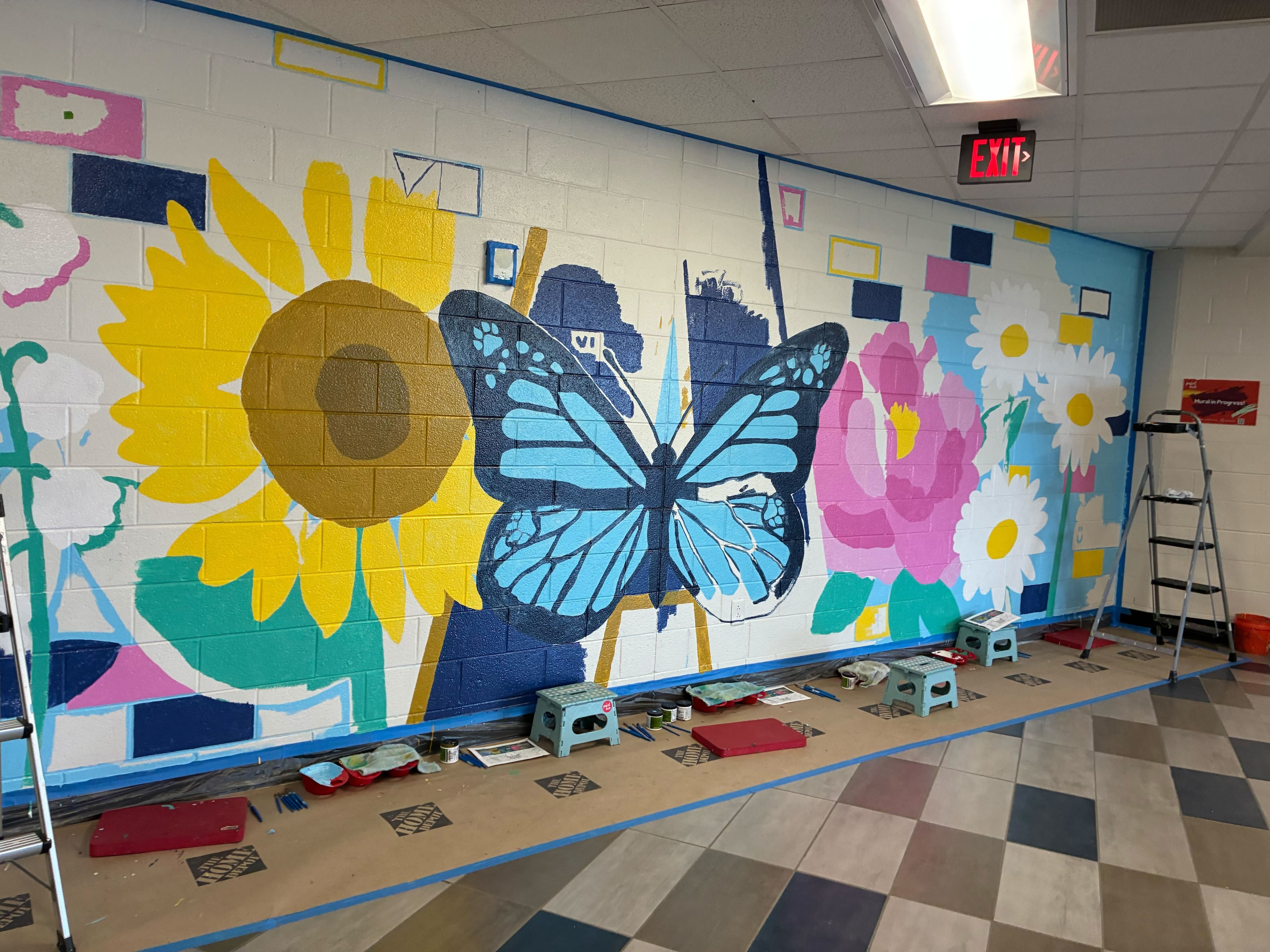 A sunflower, which blooms toward the sun, is symbolic for "students reaching for the light," said artist Elaine Stephenson, who partnered with Apalachee High School and nonprofit Paint Love to brighten the hall with new mural. (Courtesy of Paint Love)