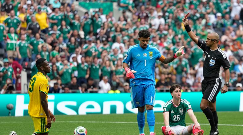 Referee Wilton Sampaio a red card to South Africa's Sphephelo Sithole, left, during the World Cup Group A soccer match between Mexico and South Africa in Mexico City, Thursday, June 11, 2026. (AP Photo/Natacha Pisarenko)