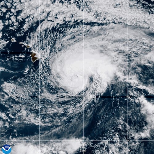 This NOAA satellite image taken at 5:22 p.m. EST on Friday, Aug. 14, 2026, shows Tropical Storm Lala as it approaches Hawaii's Big Island. (NOAA via AP)
