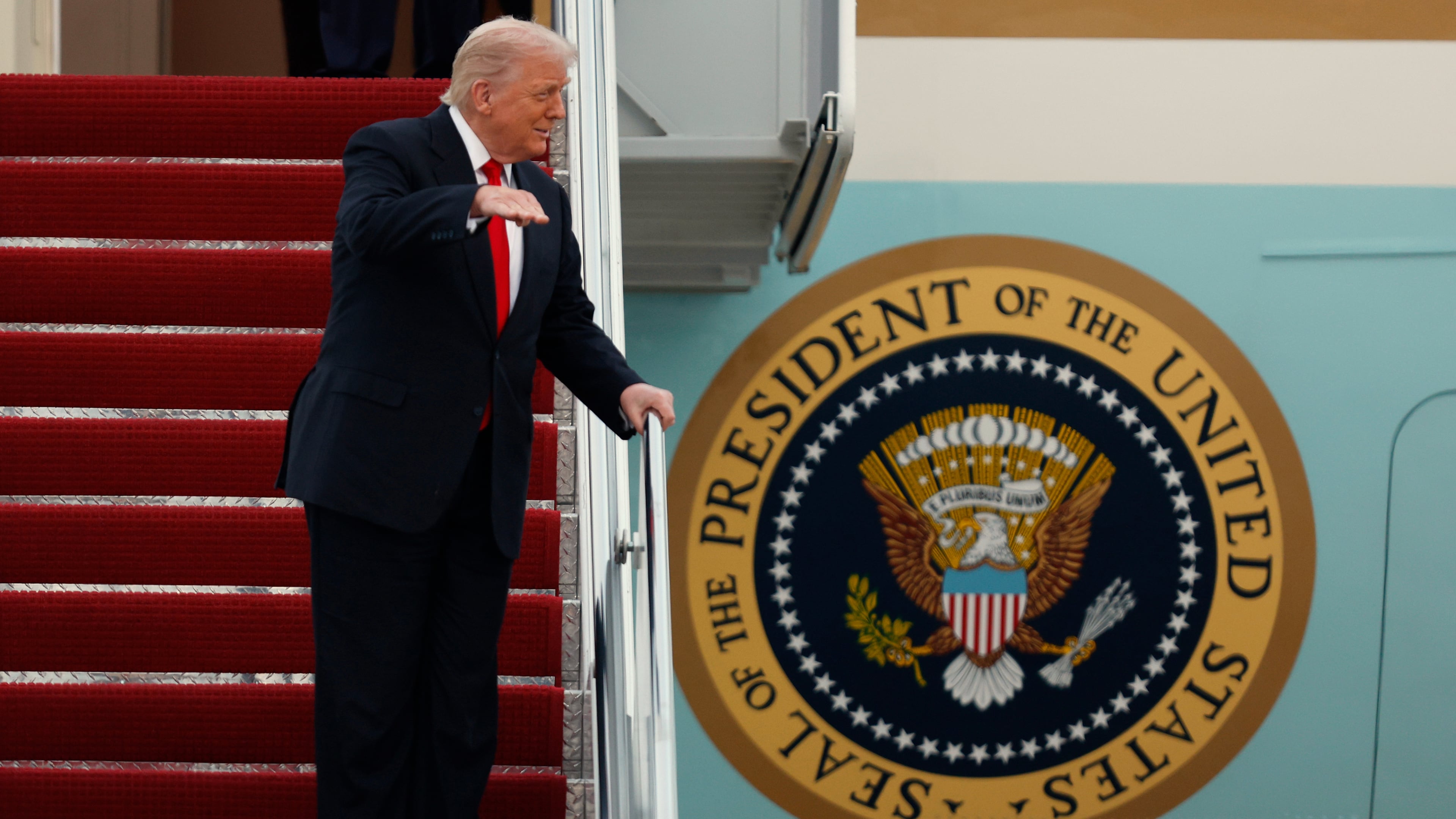 President Donald Trump gestures toward the media as he walks down the stairs of Air Force One upon his arrival at Joint Base Andrews, Md., Sunday, Nov. 9, 2025, after returning from his Mar-a-Lago estate in Palm Beach, Fla. and en route to an NFL football game between the Washington Commanders and the Detroit Lions. (AP Photo/Luis M. Alvarez)