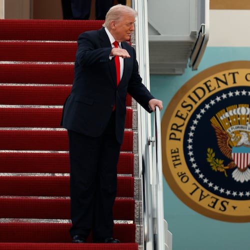 President Donald Trump gestures toward the media as he walks down the stairs of Air Force One upon his arrival at Joint Base Andrews, Md., Sunday, Nov. 9, 2025, after returning from his Mar-a-Lago estate in Palm Beach, Fla. and en route to an NFL football game between the Washington Commanders and the Detroit Lions. (AP Photo/Luis M. Alvarez)