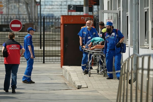 Emergency medics transport a wounded passenger at the railway station in Moscow, Russia, Sunday, June 1, 2025, after a road bridge collapsed on top of a passenger train in the Bryansk region, located on Russia's border with Ukraine. (AP Photo)