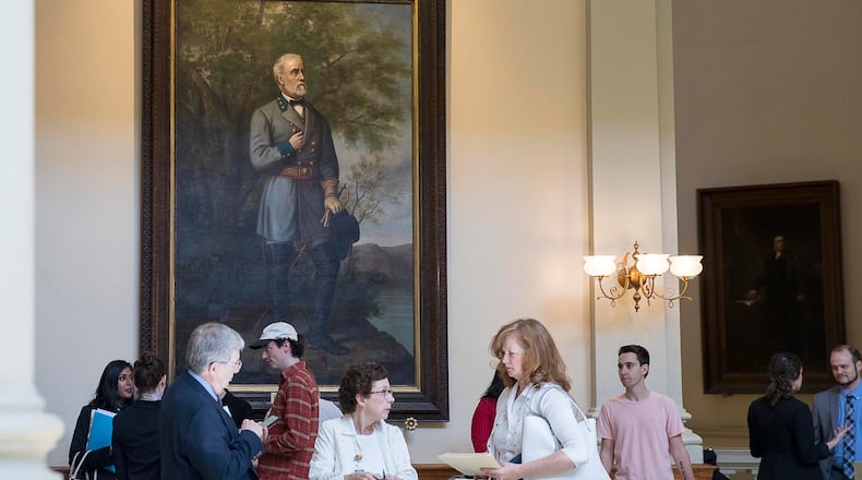 People stand near a portrait of Confederate General Robert E. Lee during the 38th day of legislation at the Georgia State Capitol building in Atlanta, Thursday, March 28, 2019.  (ALYSSA POINTER/ALYSSA.POINTER@AJC.COM)
