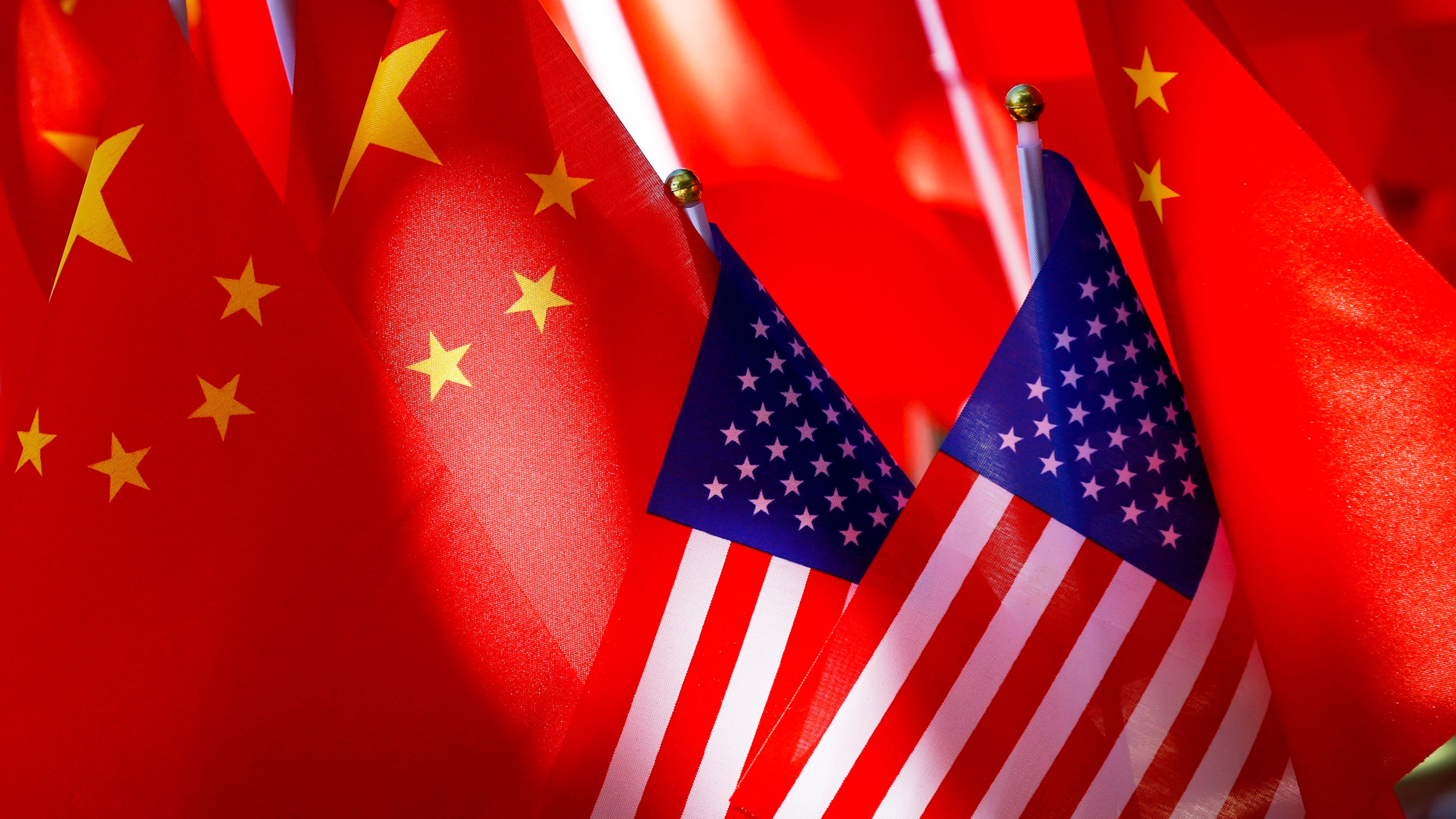 FILE - American flags are displayed with Chinese flags on Sept. 16, 2018, in Beijing. (AP Photo/Andy Wong, File)