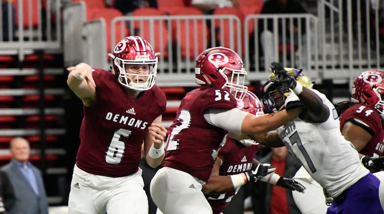 Warner Robins QB Dylan Fromm (6) passes as Bainbridge LB Eric Sanders jr., right, defends during their class 5A high school championship football game, Tuesday, Dec., 11, 2018, at Mercedes-Benz Stadium, in Atlanta.