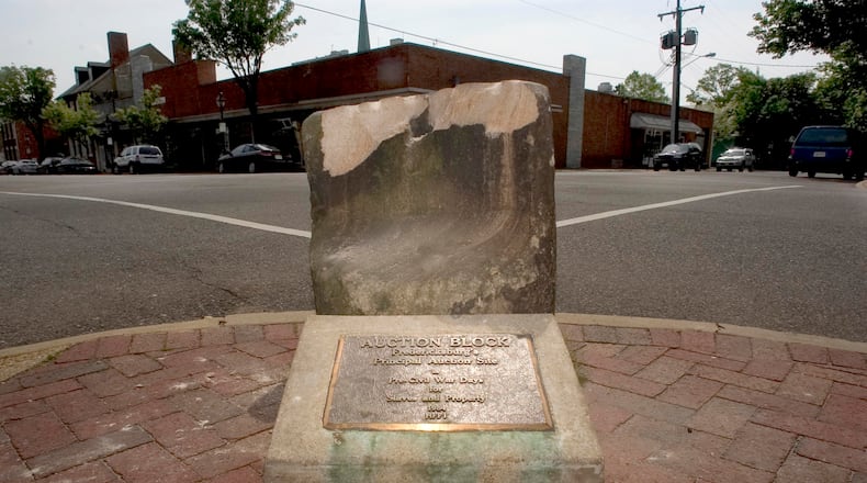A pre-Civil War auction block, which weighs 800 pounds, was pulled from the ground at a Fredericksburg street corner early Friday.