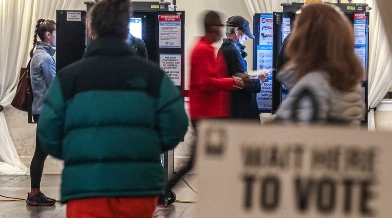 Voters surge to the machines first thing in the morning at Park Tavern on Nov. 2. (John Spink / John.Spink@ajc.com)