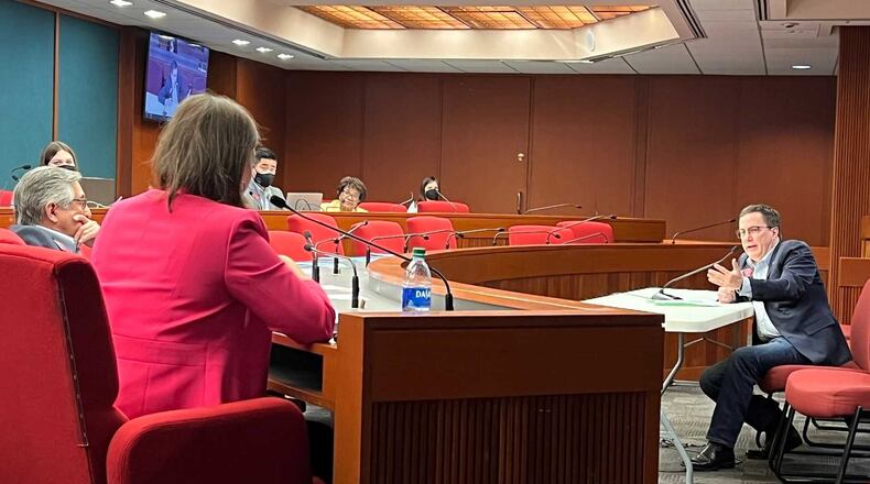 State Rep. Wes Cantrell, R-Woodstock, right, speaks to the Georgia House of Representatives higher education committee about legislation he's co-authored that would remove the 12-month waiting period for refugees to apply for in-state tuition at public colleges and universities. ERIC STIRGUS/ERIC.STIRGUS@AJC.COM.