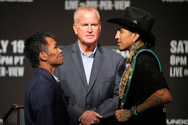 Manny Pacquiao, left, and WBC welterweight champion Mario Barrios pose at a news conference Wednesday, July 16, 2025, in Las Vegas. (AP Photo/John Locher)