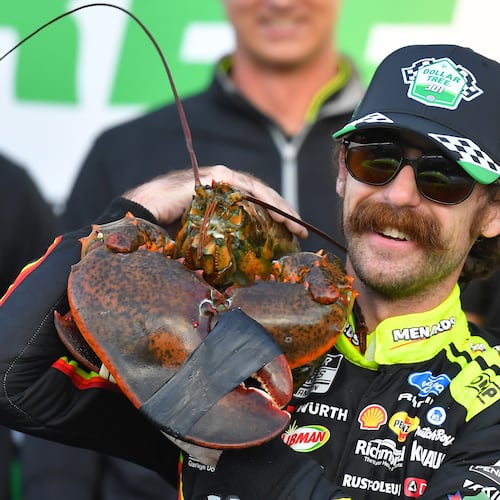 Ryan Blaney displays a lobster, a Victory Lane tradition at New Hampshire Motor Speedway, after winning a NASCAR Cup Series auto race, Sunday, Aug. 23, 2026, at the speedway in Loudon, N.H. (AP Photo/Steven Senne)