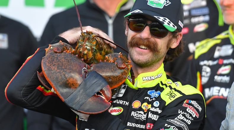 Ryan Blaney displays a lobster, a Victory Lane tradition at New Hampshire Motor Speedway, after winning a NASCAR Cup Series auto race, Sunday, Aug. 23, 2026, at the speedway in Loudon, N.H. (AP Photo/Steven Senne)