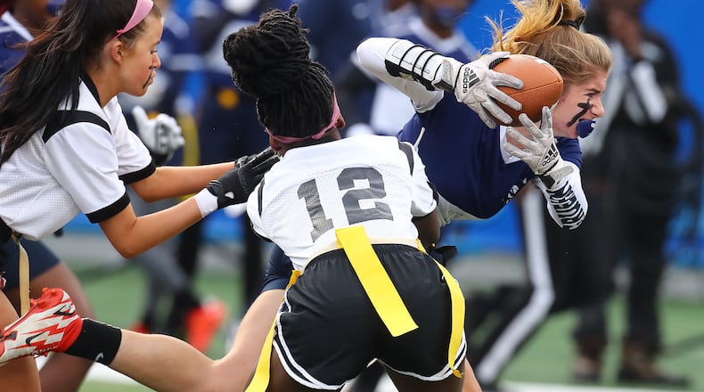 120921 Atlanta: Marietta running back Cate Gruehn makes a first down run against Hillgrove on the team's lone scoring drive in their GHSA Flag Football Championship Division 3 game on Thursday, Dec 9, 2021, in Atlanta.   “Curtis Compton / Curtis.Compton@ajc.com”`
