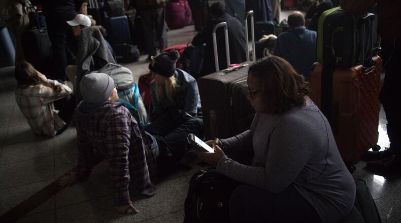Passengers wait for power to be restored on Sunday, Dec. 17, 2017, at Hartsfield-Jackson International Airport.  The outage began after 1 p.m. and lasted until about midnight.