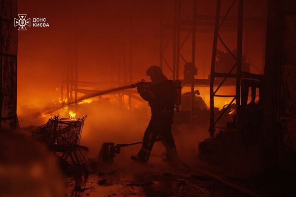 In this photo provided by the Ukrainian Emergency Service, emergency services personnel work to extinguish a fire following a Russian attack in Kyiv, Ukraine, Saturday, April 12, 2025. (Ukrainian Emergency Service via AP)